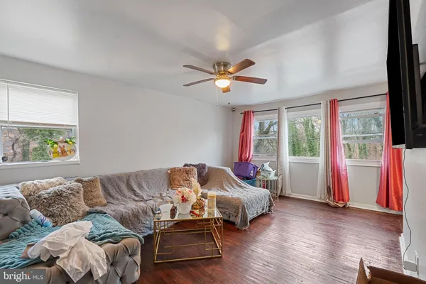 a bedroom with furniture and a large window