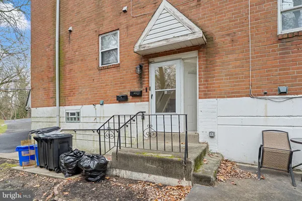 a view of a patio with table and chairs and barbeque stove