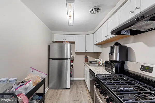 a kitchen with a stove and a refrigerator