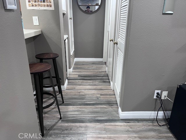 7300 Quill Drive, Unit 210 Downey, CA 90242 - Photo 6 of 12 a view of a hallway with wooden floor and staircase