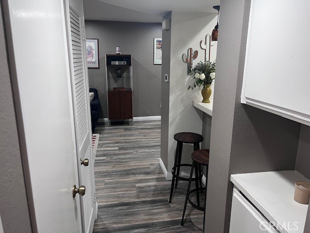 7300 Quill Drive, Unit 210 Downey, CA 90242 - Photo 7 of 12 a view of a hallway with wooden floor and stairs