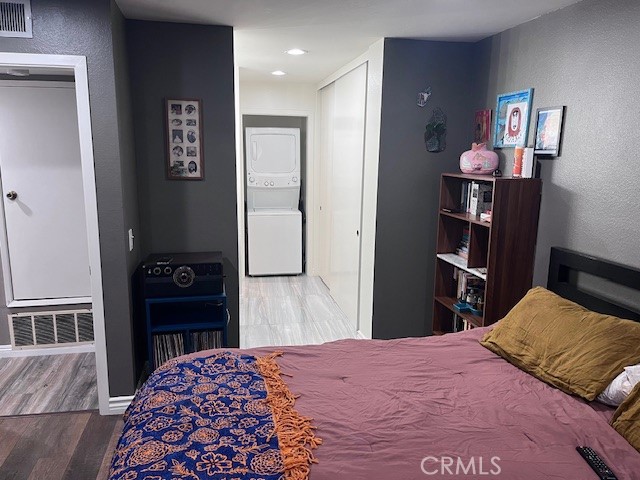 7300 Quill Drive, Unit 210 Downey, CA 90242 - Photo 9 of 12 a bedroom with a bed and a closet