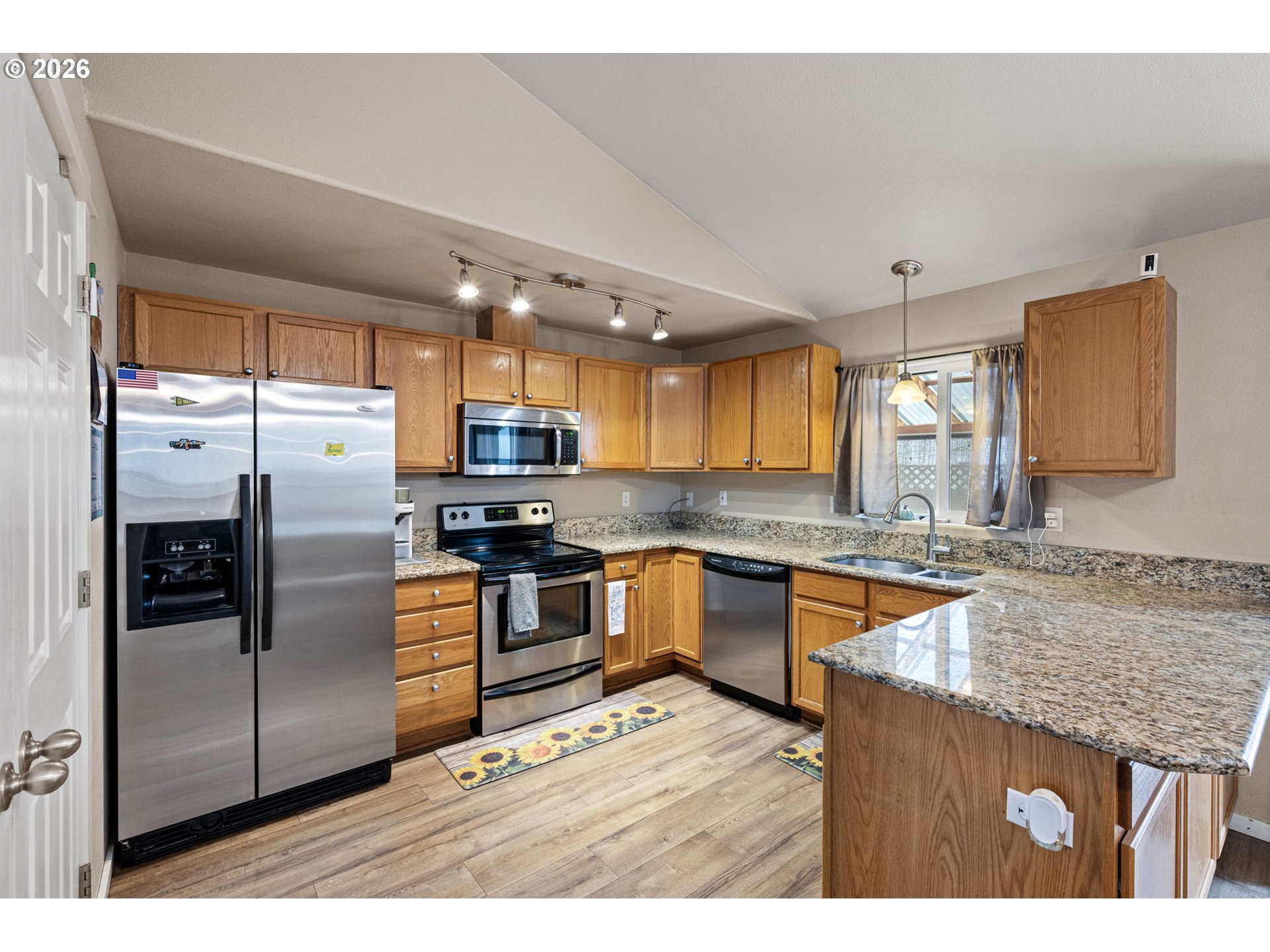 1055 Ash Grove Loop Creswell, OR 97426 - Photo 11 of 33 a kitchen with stainless steel appliances granite countertop a refrigerator a sink a stove and island