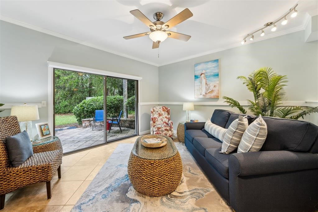 3033 Sea Marsh Road Fernandina Beach, FL 32034 - Photo 16 of 37 a living room with furniture and a large window