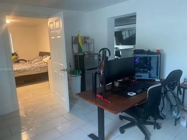 a view of a workspace with furniture and a gate