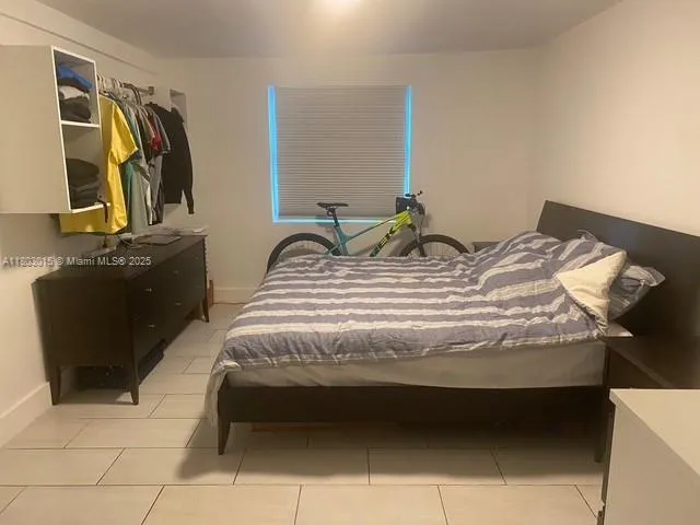 a bedroom with a bed and dresser