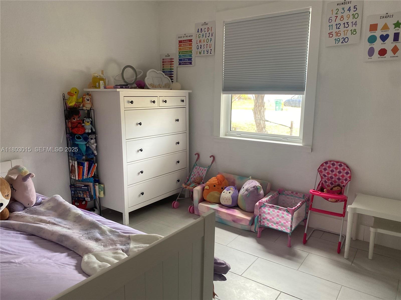 3915 Lotus Drive Naples, FL 34104 - Photo 22 of 25 a bedroom with a bed and a window