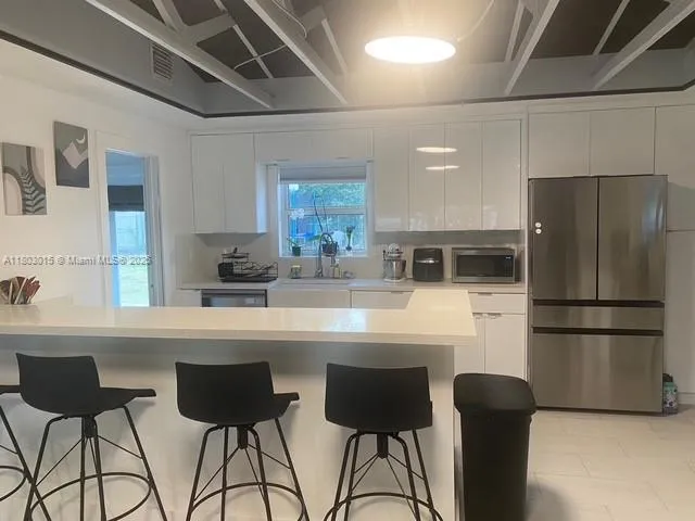 a kitchen with cabinets and stainless steel appliances