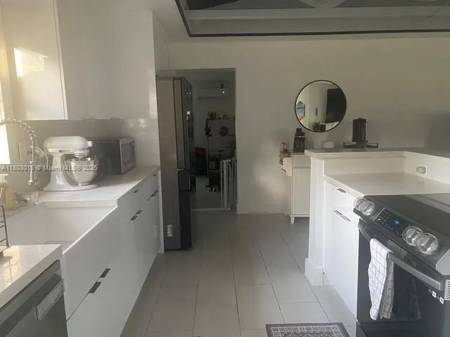 a utility room with sink dryer and washer