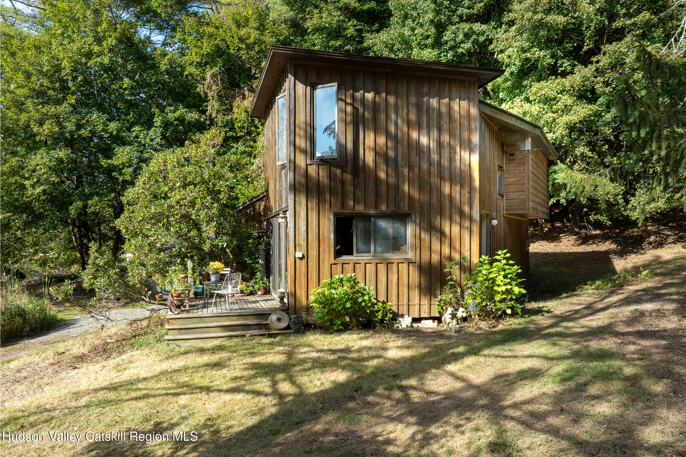 1635 High Falls Road Catskill, NY 12414 - Photo 5 of 43 a view of brick house with large windows and a small yard