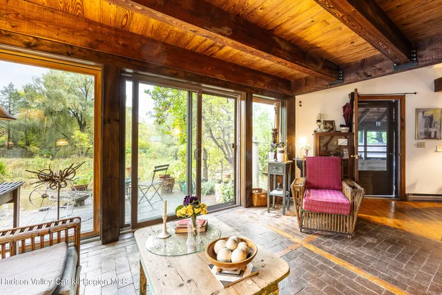a living room with patio furniture and a wooden floor