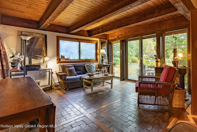 a livingroom with furniture wooden floor and a rug