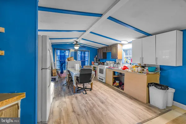 a kitchen with a dining table chairs and kitchen view