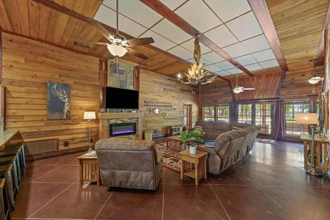 a living room with fireplace furniture and a flat screen tv