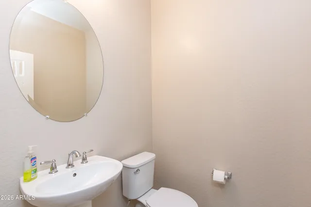 a white toilet sitting next to a white sink