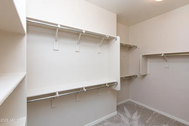 a view of walk in closet with empty racks