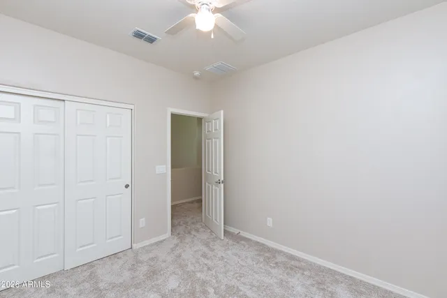 an empty room with a ceiling fan