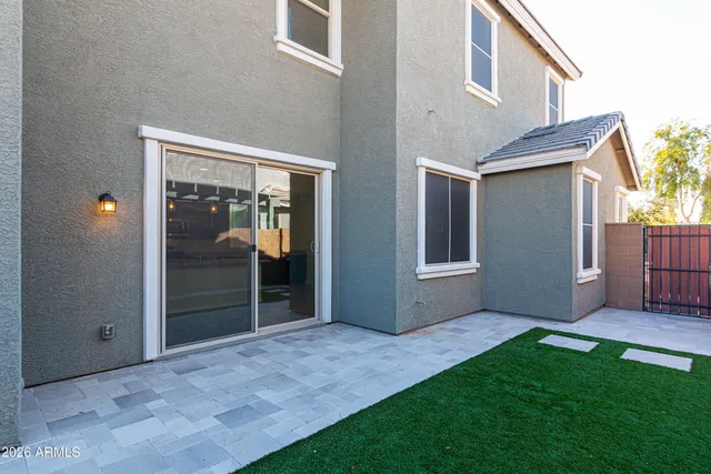 a view of an house with backyard and porch