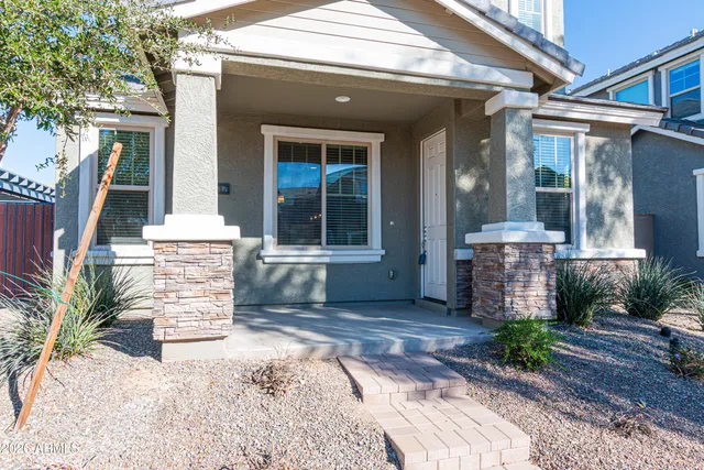 a front view of a house with a garden