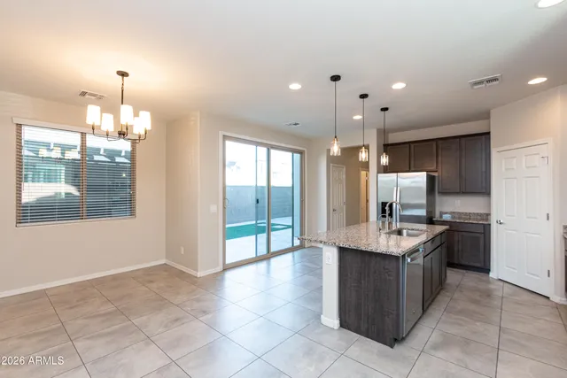 a large kitchen with kitchen island granite countertop a large counter top and stainless steel appliances
