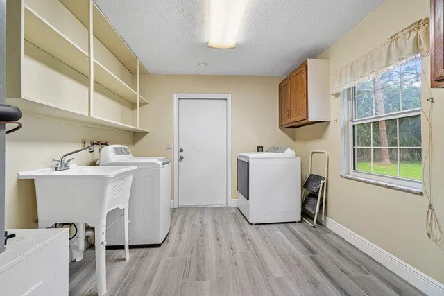 a utility room with a sink dryer and washer