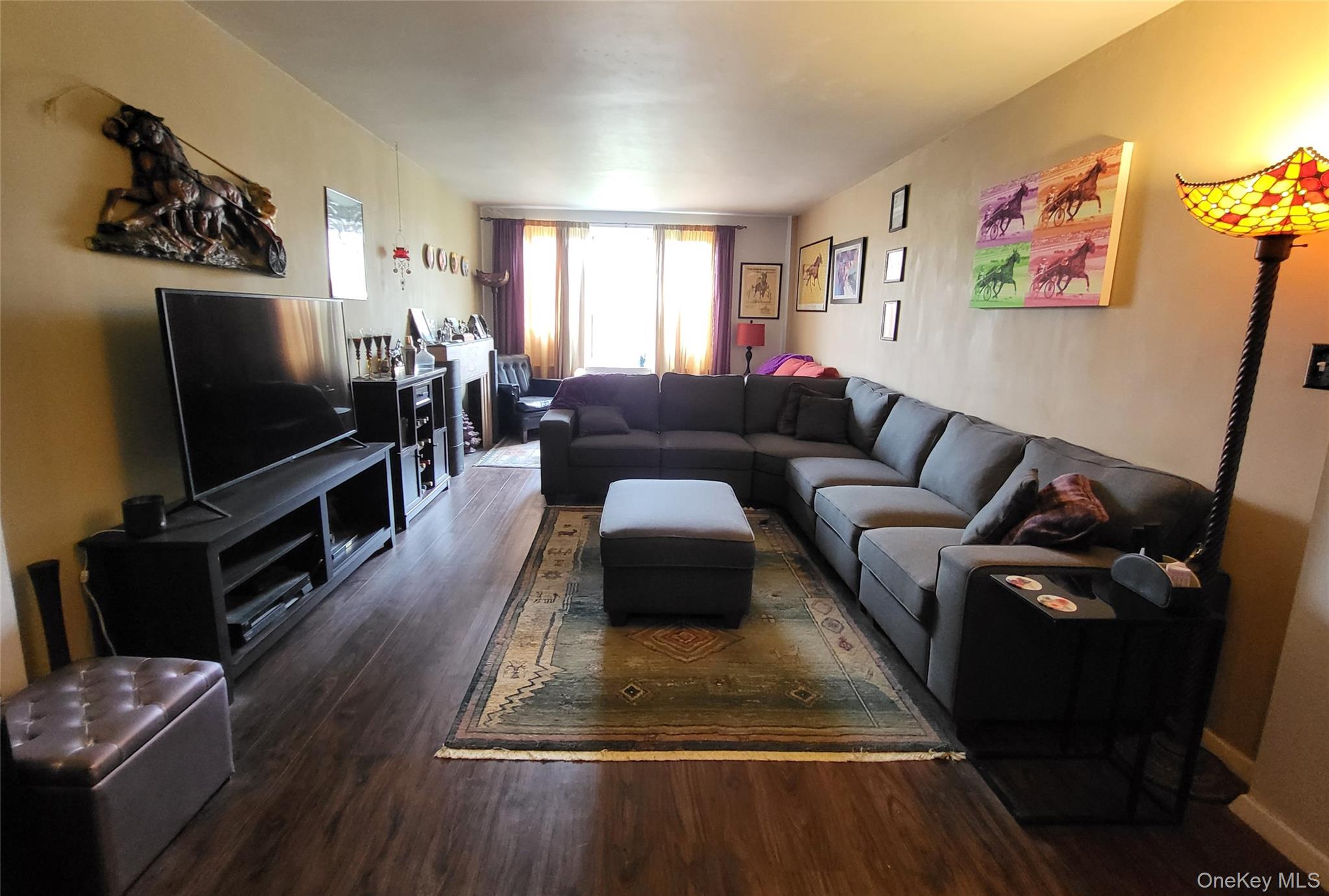 3176 Decatur Avenue, Unit 6H Bronx, NY 10467 - Photo 2 of 12 Spacious living area featuring wood-finish flooring, and ample natural light from the far window