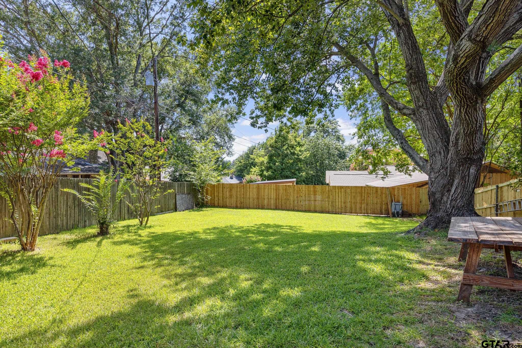 802 Carriage Drive Tyler, TX 75703 - Photo 16 of 21 a view of yard with trees and wooden fence