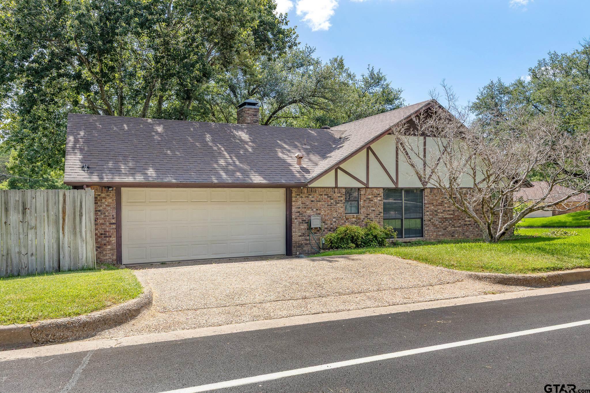 802 Carriage Drive Tyler, TX 75703 - Photo 19 of 21 a front view of a house with a yard and garage