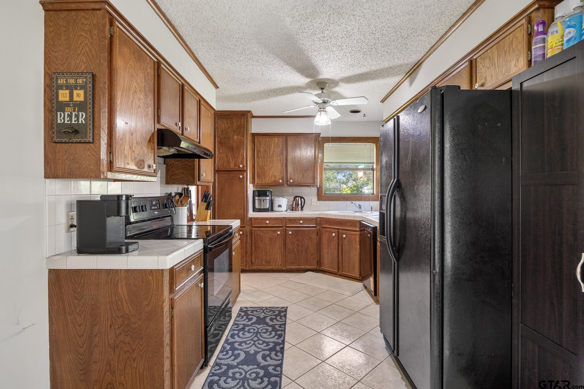 802 Carriage Drive Tyler, TX 75703 - Photo 20 of 21 a kitchen with stainless steel appliances granite countertop a refrigerator a stove and a sink