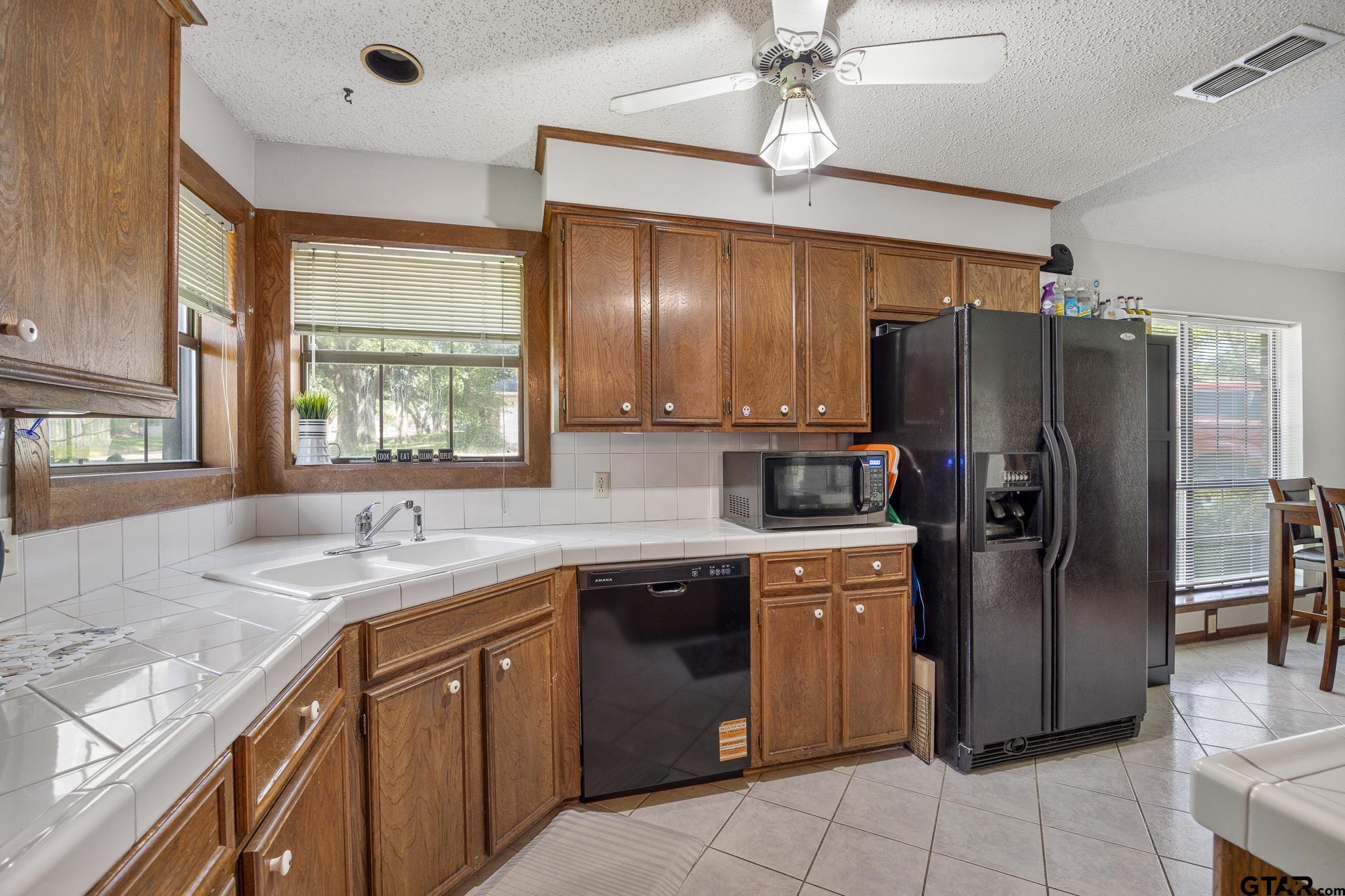 802 Carriage Drive Tyler, TX 75703 - Photo 2 of 21 a kitchen with stainless steel appliances granite countertop a sink stove and refrigerator