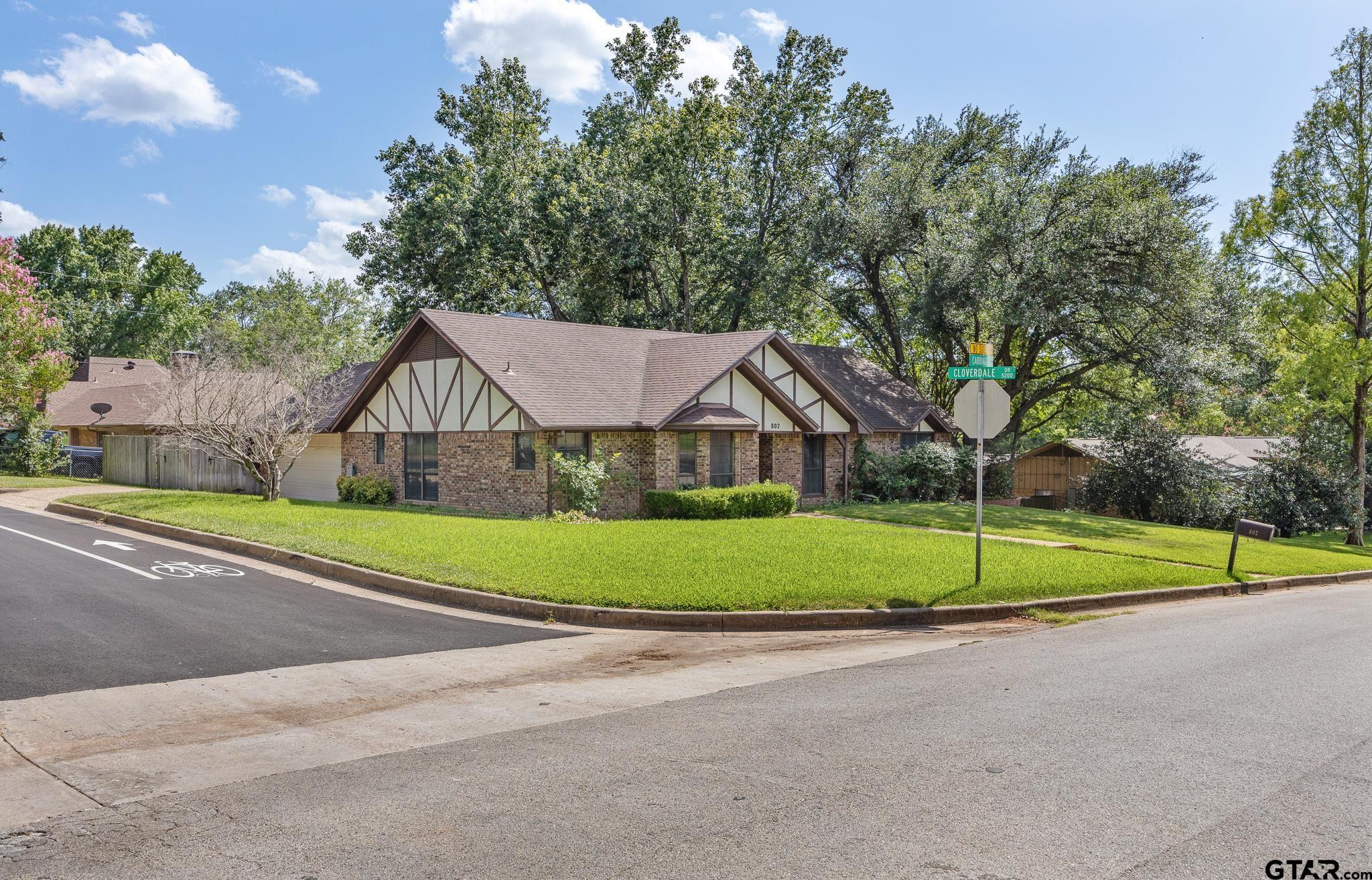 802 Carriage Drive Tyler, TX 75703 - Photo 3 of 21 a house with green field in front of it