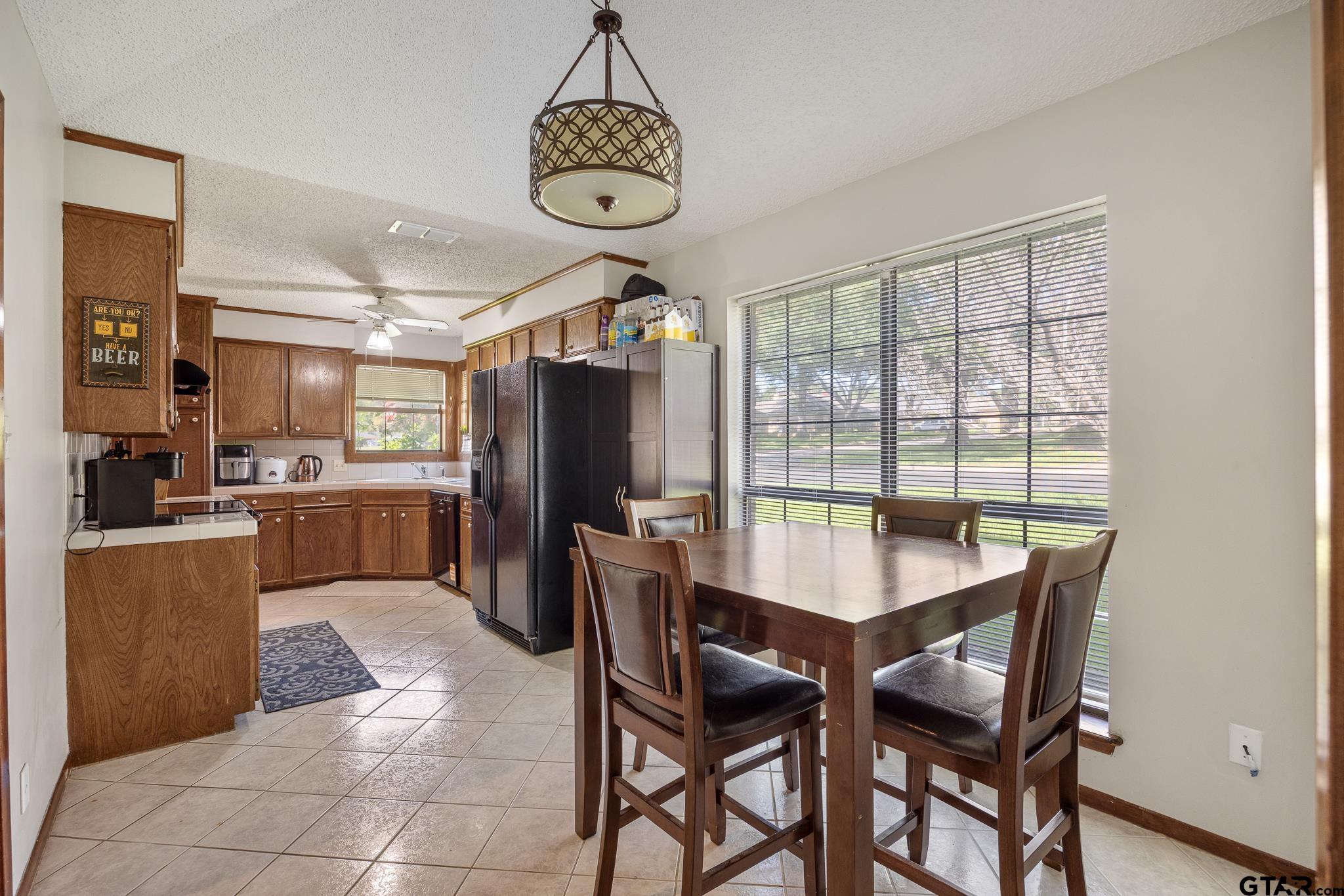 802 Carriage Drive Tyler, TX 75703 - Photo 8 of 21 a dining room with furniture a chandelier and wooden floor