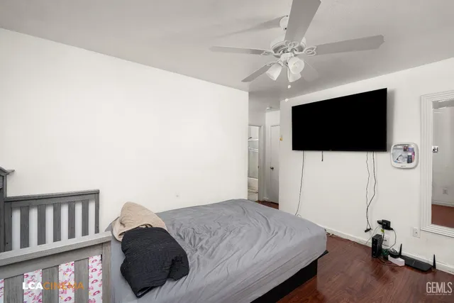 a bedroom with a bed and a flat screen tv