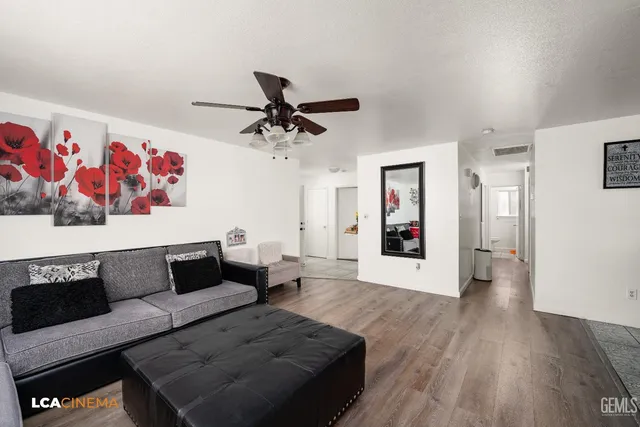 a living room with furniture and wooden floor