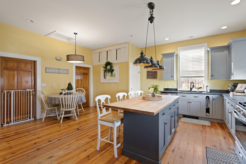 22 Sanderson Road Littleton, MA 01460 - Photo 13 of 30 a kitchen with wooden floor and white appliances