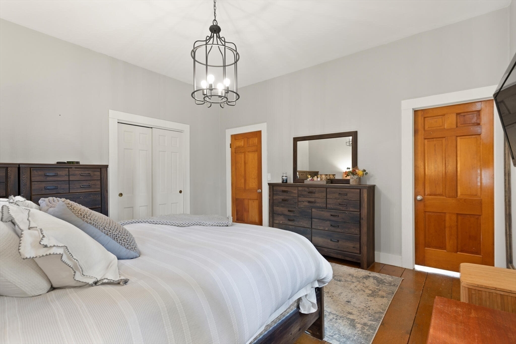 22 Sanderson Road Littleton, MA 01460 - Photo 20 of 30 a bedroom with a bed and wooden floor