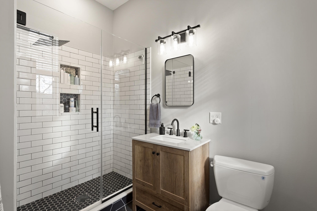22 Sanderson Road Littleton, MA 01460 - Photo 21 of 30 a bathroom with a toilet sink and mirror