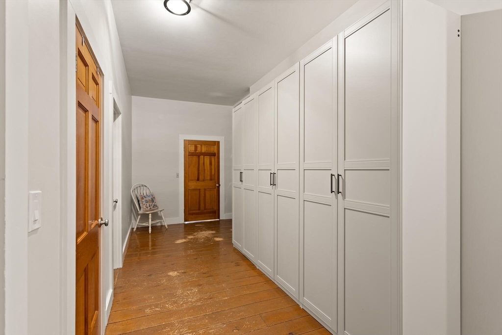 22 Sanderson Road Littleton, MA 01460 - Photo 25 of 30 a view of a hallway with wooden floor and closet