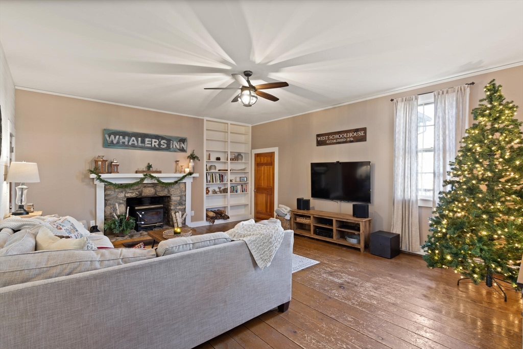 22 Sanderson Road Littleton, MA 01460 - Photo 6 of 30 a living room with furniture a fireplace and a flat screen tv