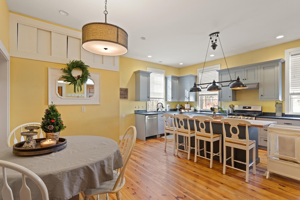 22 Sanderson Road Littleton, MA 01460 - Photo 9 of 30 a kitchen with stainless steel appliances wooden floor dining table and chairs