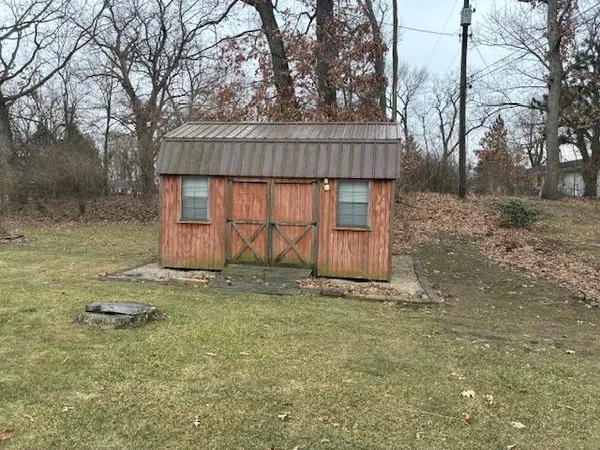 a living room with furniture a flat screen tv and a large window
