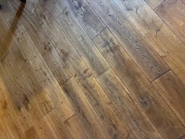 a view of a bedroom with a bed and wooden floor