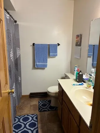 a living room with furniture a fireplace and a large window