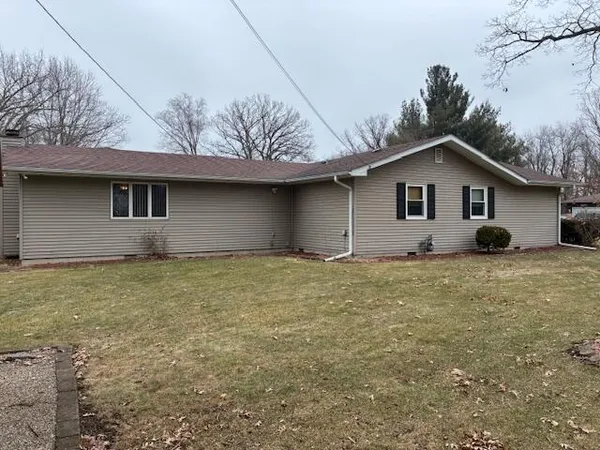 a view of a wooden door covered with snow in the yard