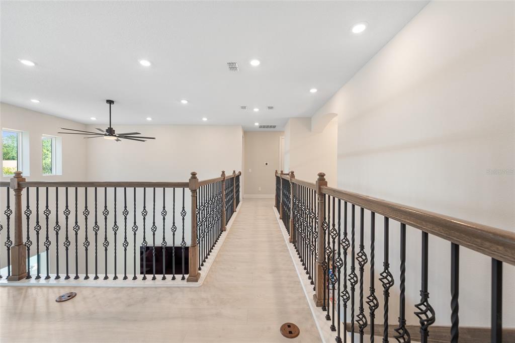 10175 Brocksport Circle Gotha, FL 34734 - Photo 32 of 54 a view of a hallway with wooden floor and windows