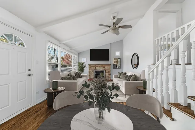 a living room with furniture a flat screen tv and a window