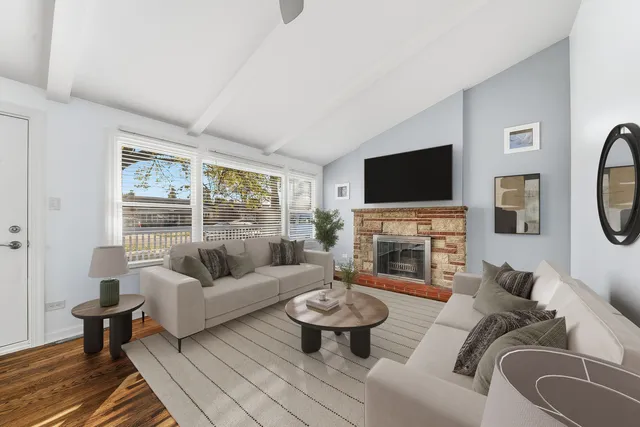 a living room with furniture a fireplace and a flat screen tv