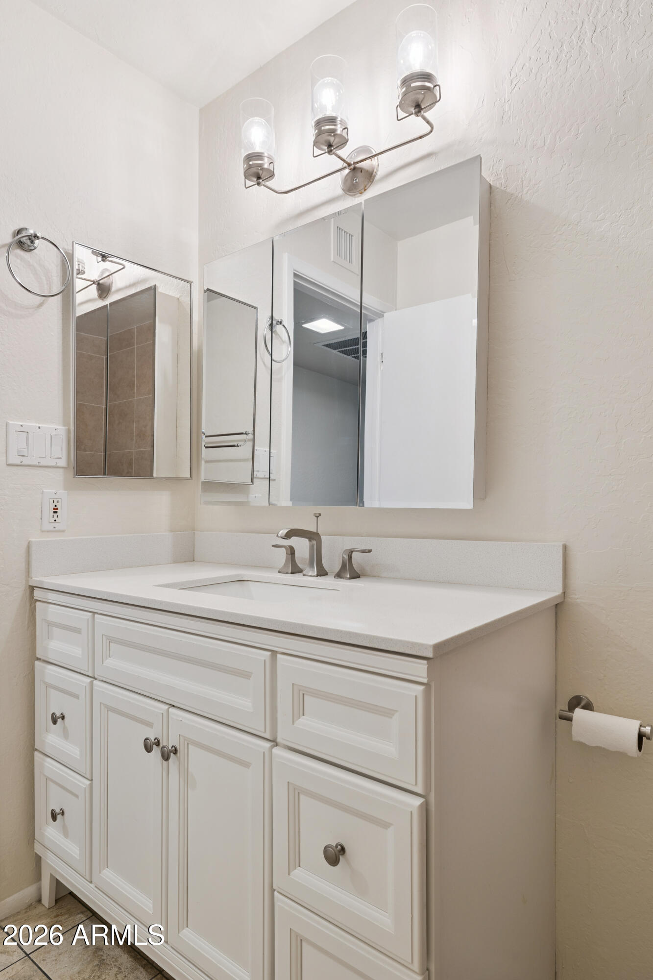 4343 East Osborn Road Phoenix, AZ 85018 - Photo 21 of 41 a bathroom with a sink and a mirror