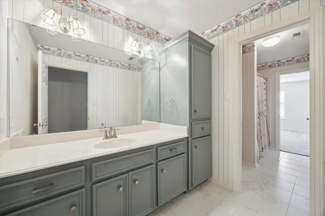 a spacious bathroom with a double vanity sink and a mirror