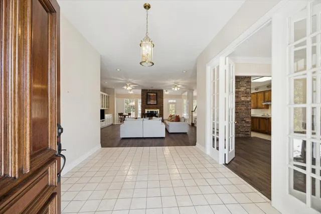 a view of a bedroom with a bed and wooden floor